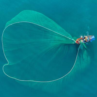 A fishing boat deploys its net